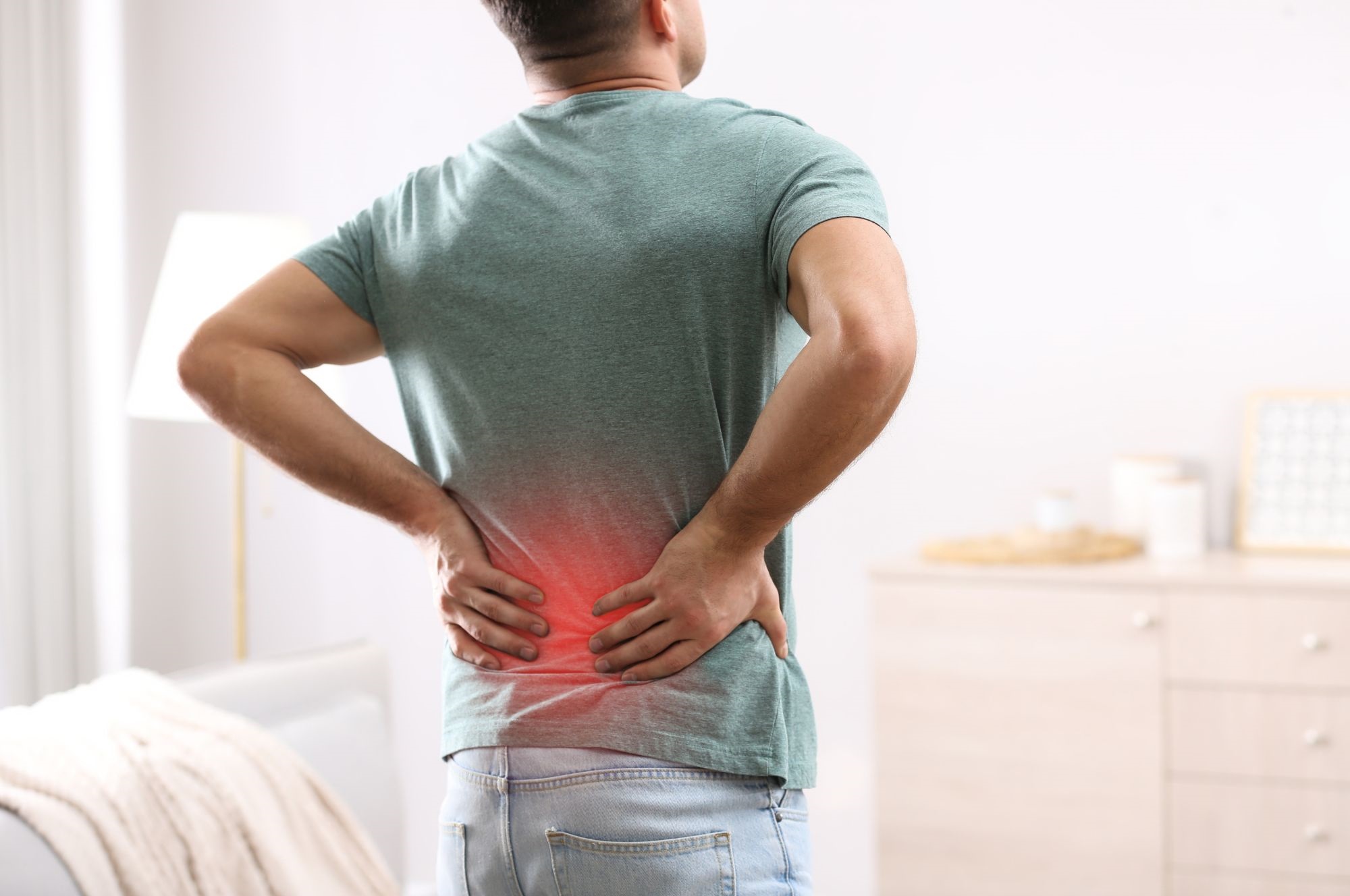 A Man Suffering From Lower Back Pain. blog by the back pain experts in lake country.